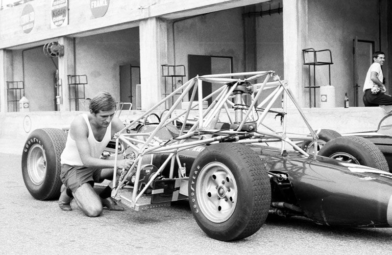 Otto working on a race car, 1960s